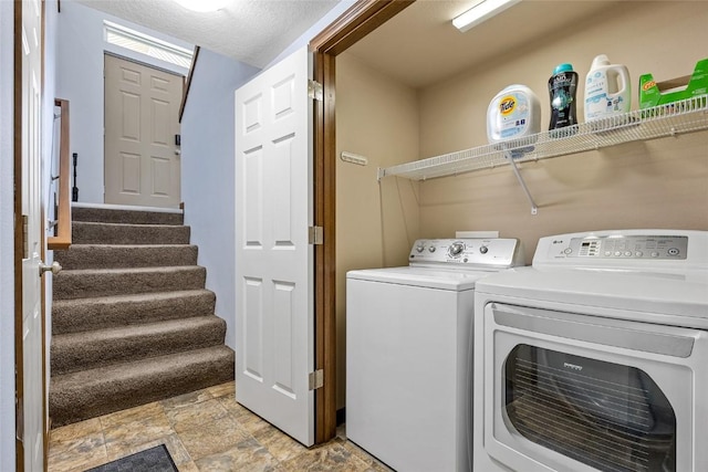 clothes washing area with washer and clothes dryer