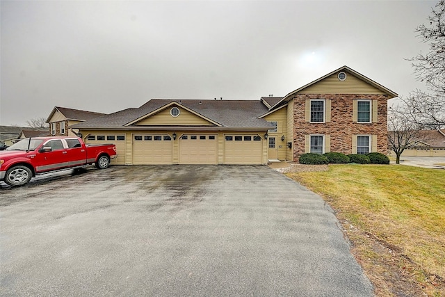 view of front of house with a garage and a front lawn