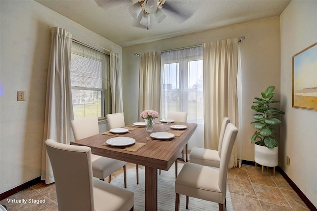 dining room featuring ceiling fan and a textured ceiling