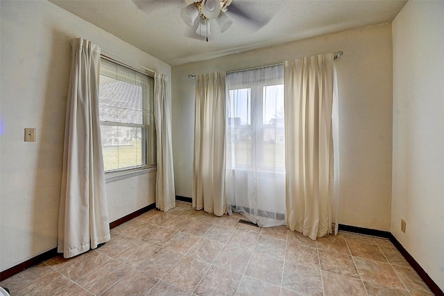 spare room featuring ceiling fan and a textured ceiling