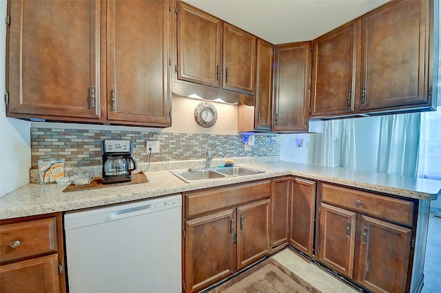 kitchen featuring sink, backsplash, and dishwasher