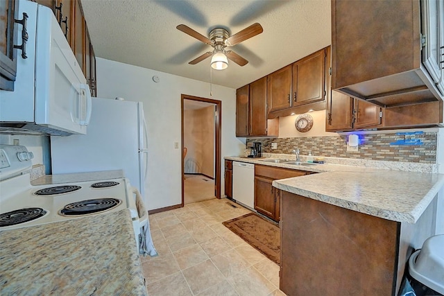 kitchen featuring ceiling fan, white appliances, sink, and decorative backsplash