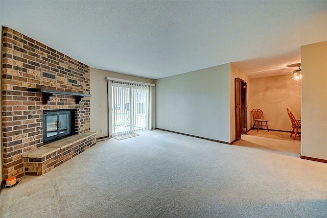 unfurnished living room with light carpet, a textured ceiling, and a fireplace