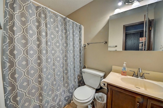 bathroom featuring vanity, toilet, and a textured ceiling