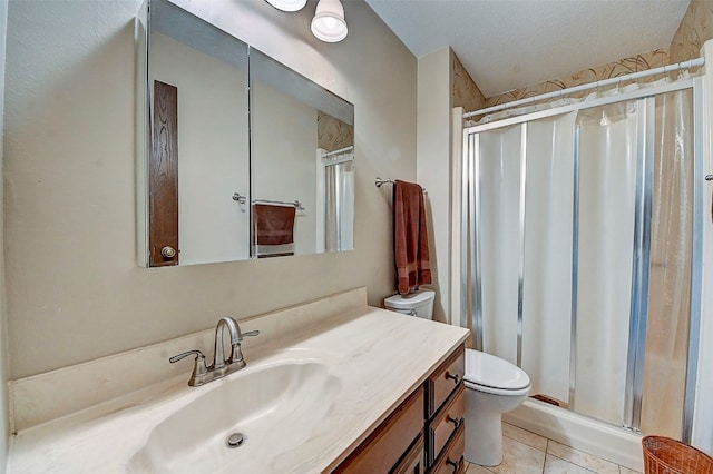 bathroom featuring vanity, an enclosed shower, a textured ceiling, and toilet