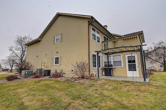 back of house featuring a patio, a lawn, cooling unit, and a pergola