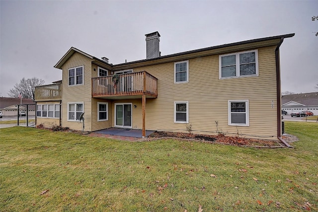 rear view of house with a lawn and a patio area