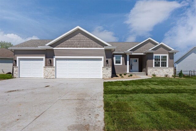 750 Hampshire Dr, Marion, IA 52302 - craftsman-style home featuring stone siding, an attached garage, a front lawn, and driveway