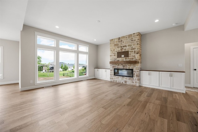 750 Hampshire Dr, Marion, IA 52302 - unfurnished living room with light wood-type flooring, a fireplace, and recessed lighting