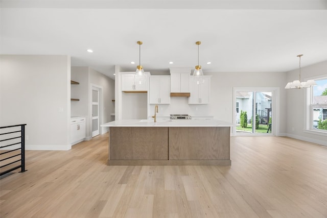 750 Hampshire Dr, Marion, IA 52302 - kitchen featuring white cabinets, light countertops, light wood finished floors, a large island with sink, and recessed lighting
