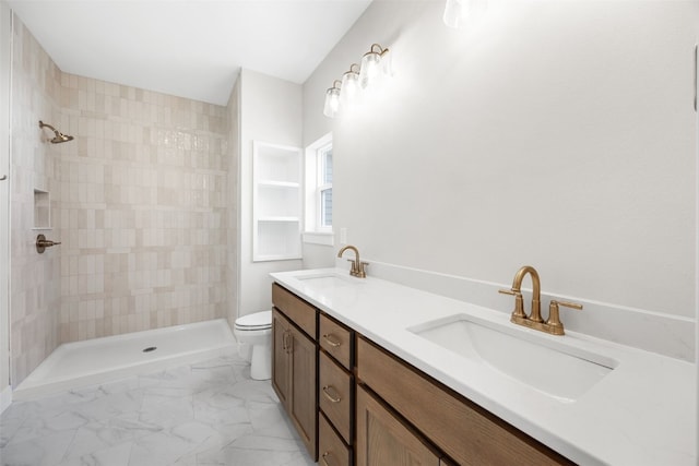 750 Hampshire Dr, Marion, IA 52302 - bathroom with double vanity, a tile shower, and marble finish flooring