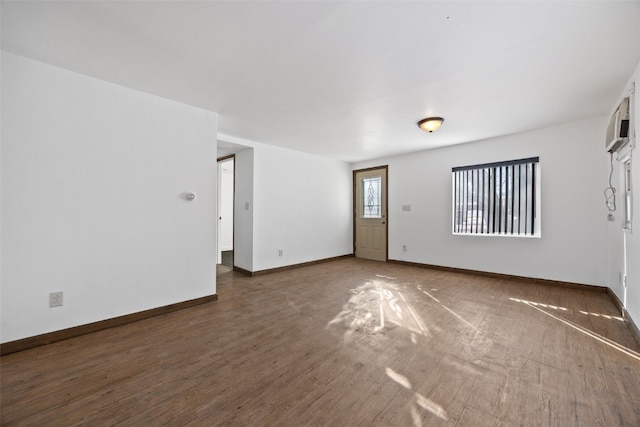 unfurnished room with dark hardwood / wood-style flooring