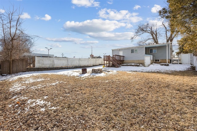 yard layered in snow featuring a wooden deck