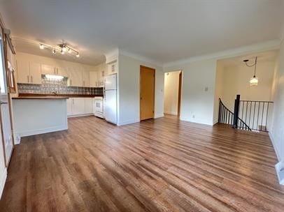 unfurnished living room with hardwood / wood-style floors