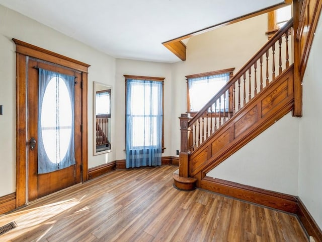 entrance foyer with wood-type flooring and a healthy amount of sunlight