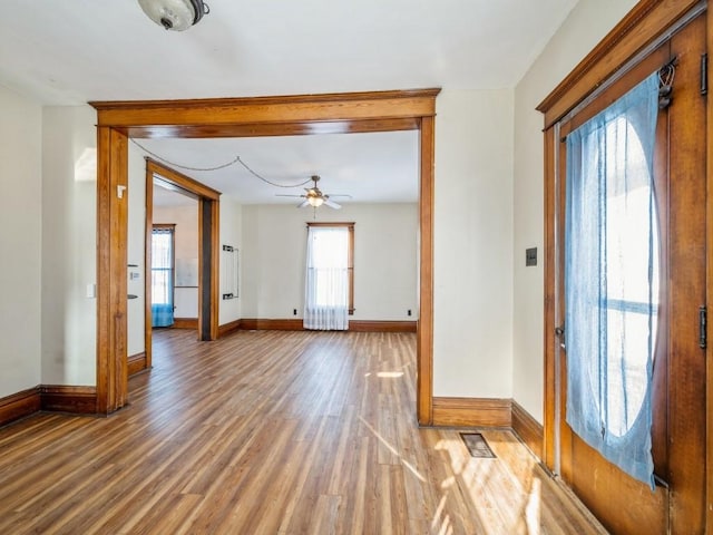 entrance foyer featuring ceiling fan, wood finished floors, and baseboards