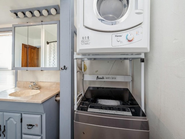 interior space featuring sink and stacked washing maching and dryer