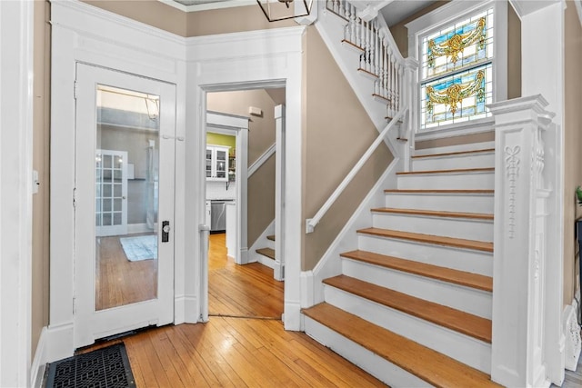 stairs featuring hardwood / wood-style floors