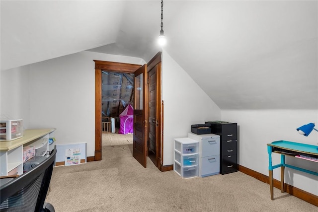 office with lofted ceiling and light colored carpet