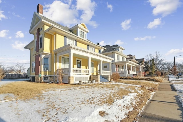 view of front facade with central AC and covered porch