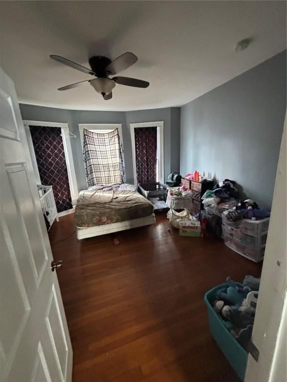 bedroom with ceiling fan and dark hardwood / wood-style flooring