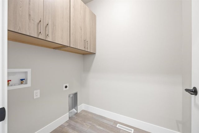 washroom featuring cabinets, hookup for an electric dryer, washer hookup, and light wood-type flooring