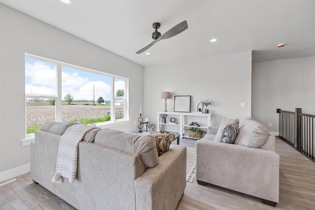 living room featuring ceiling fan, a healthy amount of sunlight, and light hardwood / wood-style floors