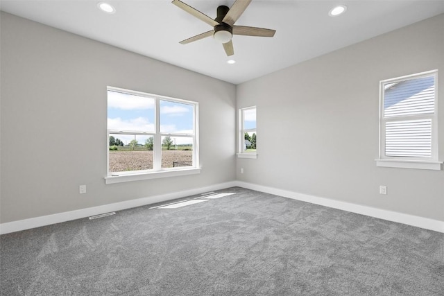 spare room with carpet and ceiling fan