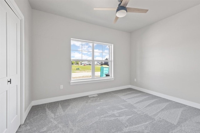 empty room featuring ceiling fan and carpet flooring