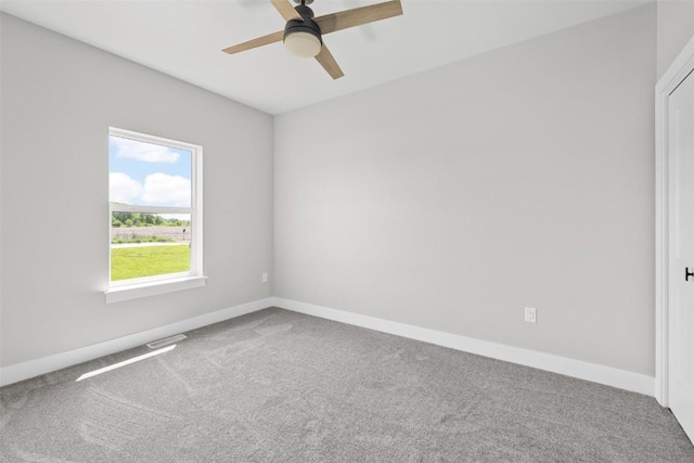 spare room featuring ceiling fan and carpet flooring