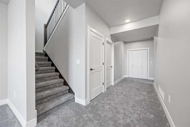 hallway with carpet floors