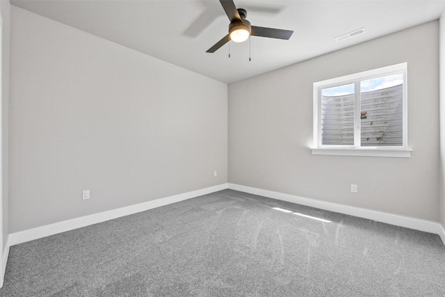 carpeted spare room with ceiling fan