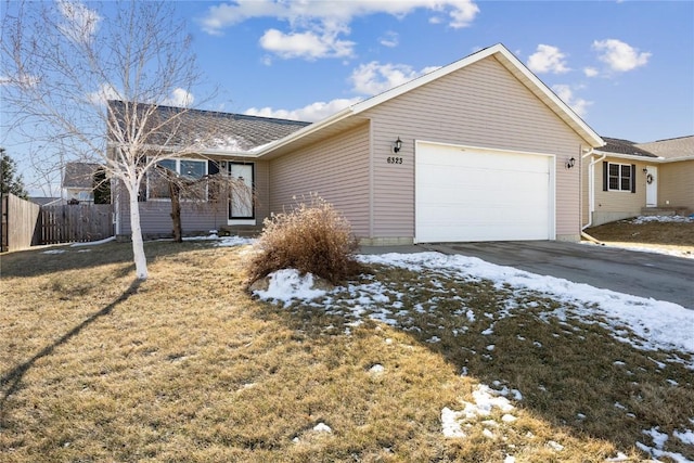 view of front of property with a garage and a lawn