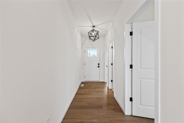 corridor featuring a chandelier and hardwood / wood-style floors