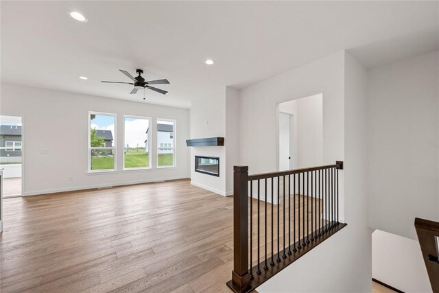 living room featuring ceiling fan and light wood-type flooring