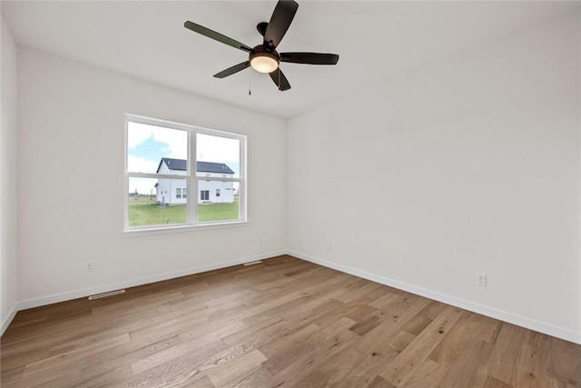 spare room featuring ceiling fan and light wood-type flooring