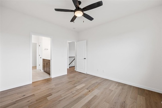 unfurnished bedroom featuring ceiling fan, ensuite bath, and light wood-type flooring