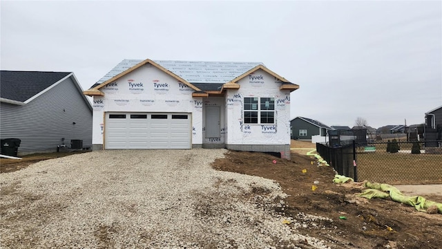 unfinished property with a garage and cooling unit