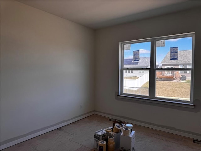 spare room with baseboards
