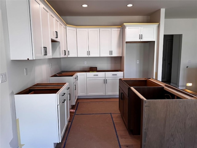 kitchen featuring a center island, white cabinetry, tile patterned flooring, and recessed lighting