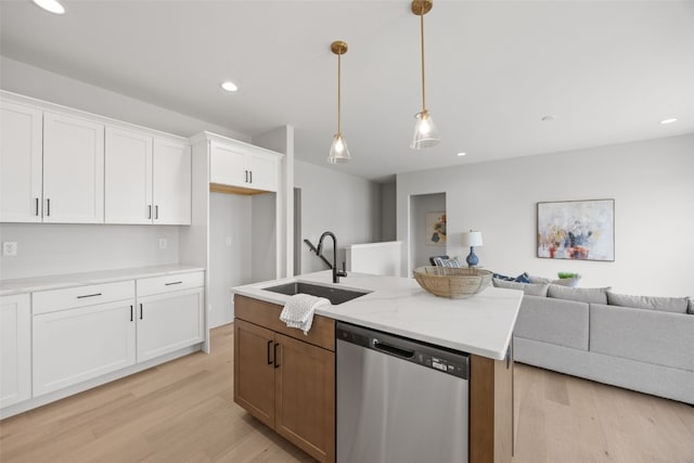 8908 Norway Dr NE, Cedar Rapids, IA 52402 - kitchen with stainless steel dishwasher, a sink, open floor plan, light wood finished floors, and white cabinets
