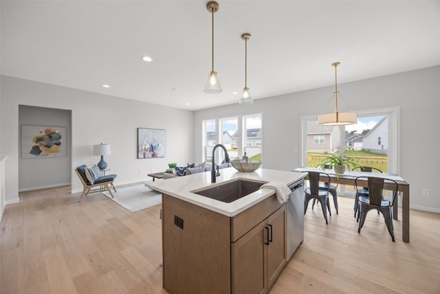 8908 Norway Dr NE, Cedar Rapids, IA 52402 - kitchen with a sink, stainless steel dishwasher, light wood-type flooring, pendant lighting, and recessed lighting