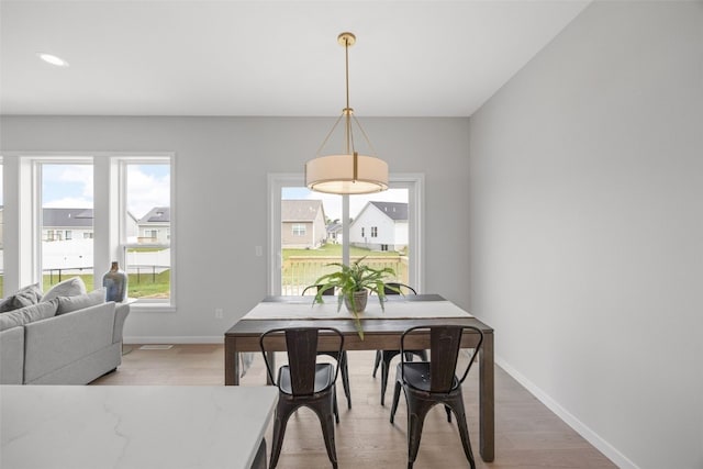 8908 Norway Dr NE, Cedar Rapids, IA 52402 - dining area featuring baseboards, light wood-style flooring, and recessed lighting