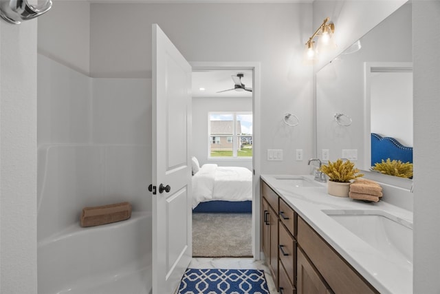 8908 Norway Dr NE, Cedar Rapids, IA 52402 - ensuite bathroom featuring double vanity, tile patterned flooring, and ceiling fan