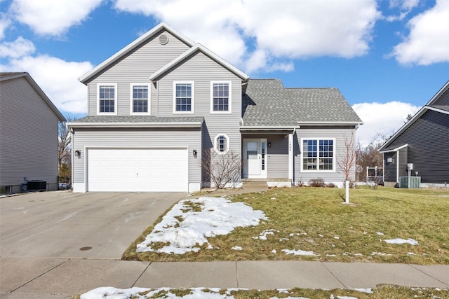 view of front property featuring a garage, central AC unit, and a front lawn