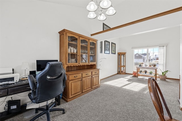 carpeted home office with an inviting chandelier and high vaulted ceiling