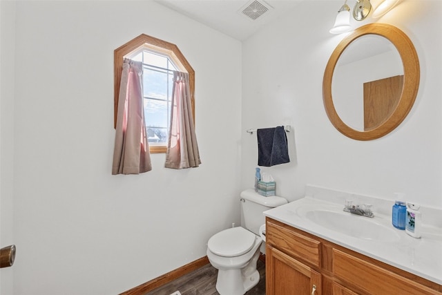 bathroom with vanity, hardwood / wood-style floors, and toilet