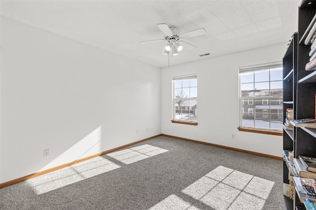 interior space with ceiling fan