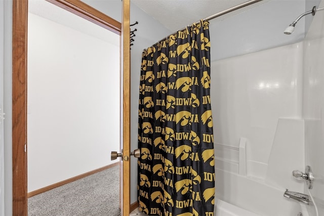 bathroom featuring shower / tub combo and a textured ceiling