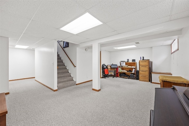 basement featuring carpet and a drop ceiling